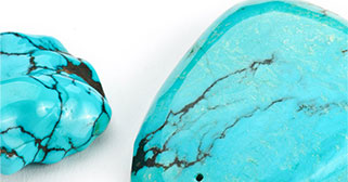 two turquoise colored stones sitting next to each other