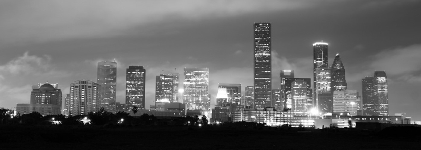 a black and white photo of a city at night