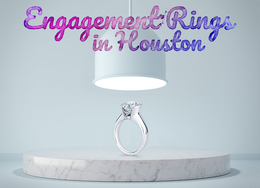 an engagement ring sits on a marble pedestal
