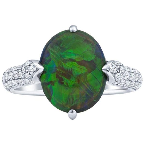 an oval shaped green ring with diamonds