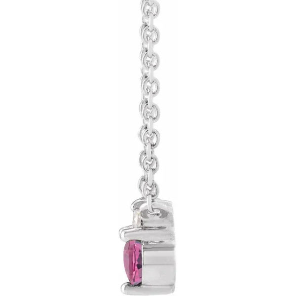a necklace with a pink stone hanging from it