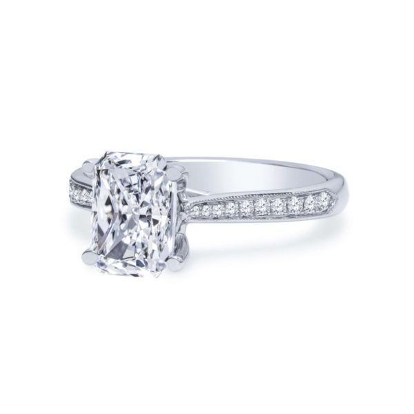 a cushion cut diamond engagement ring with channeled shoulders