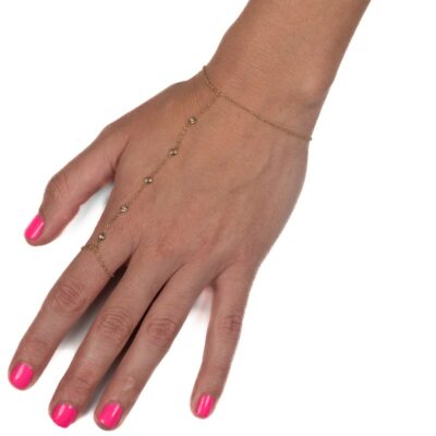 a woman's hand with pink manicures and a gold bracelet
