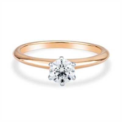 a gold engagement ring with a single diamond