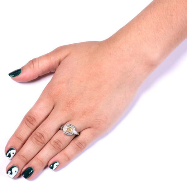 a woman's hand with green and white nail polish