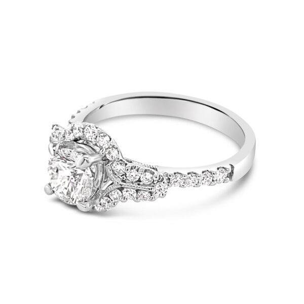 a white gold engagement ring with a cushion cut diamond