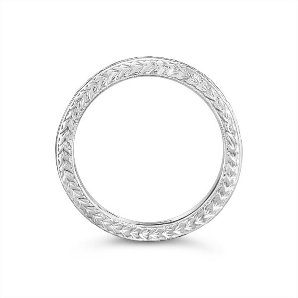 a white gold wedding ring with intricate engraving