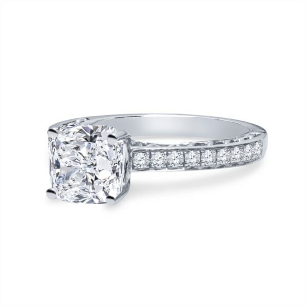 a cushion cut diamond ring with channeled shoulders
