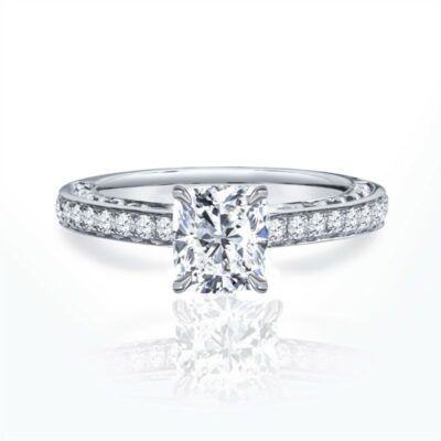 a cushion cut diamond engagement ring with pave set shoulders