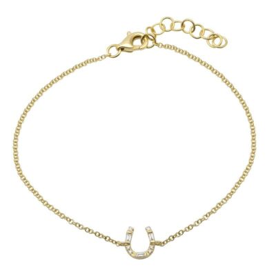 a gold bracelet with a horseshoe charm