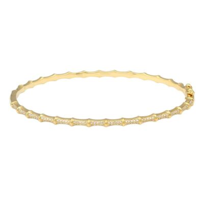 a thin gold bracelet with white stones