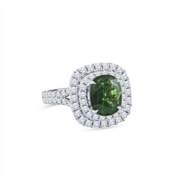 a ring with a green diamond surrounded by diamonds