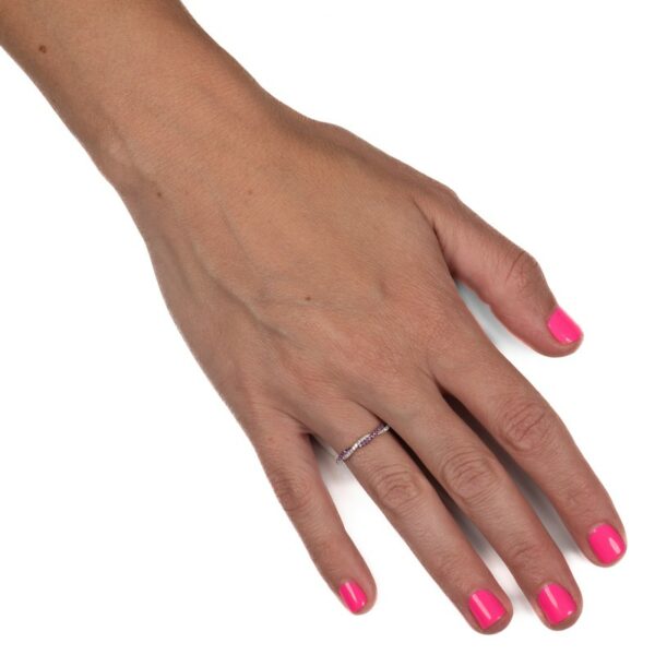a woman's hand with pink nail polish on it