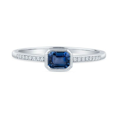 a blue sapphire and diamond ring on a white background