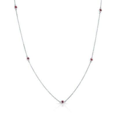 a silver necklace with red stones on it