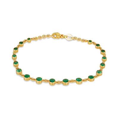 a gold bracelet with green stones