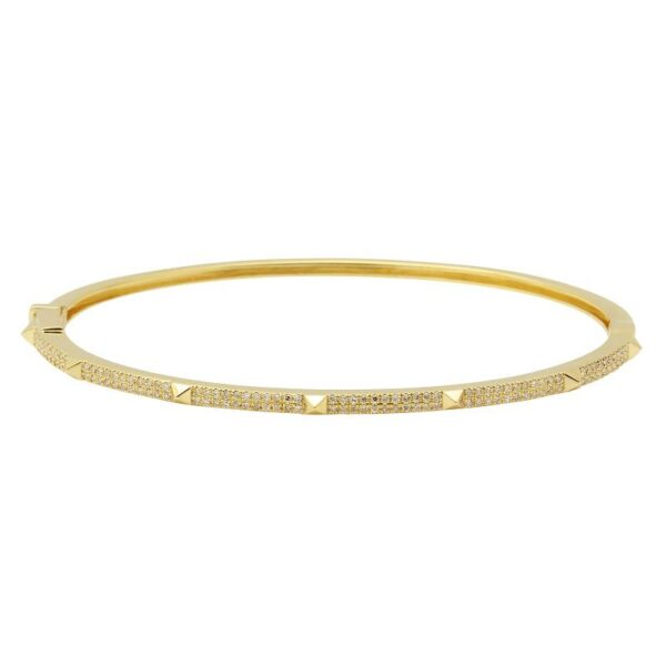 a gold bang bracelet with diamonds