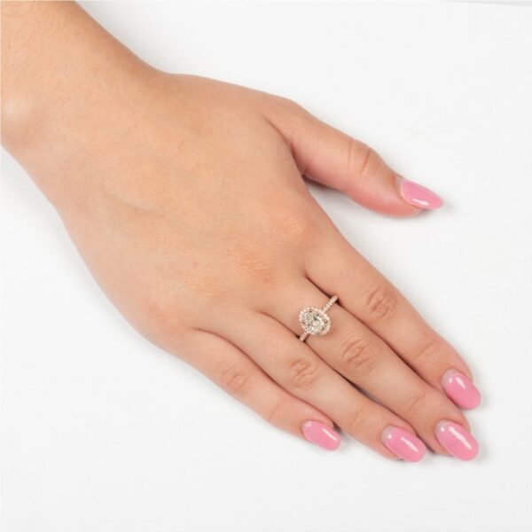 a woman's hand with pink manicures and a diamond ring