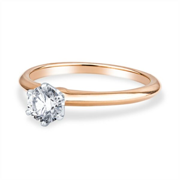a gold ring with a diamond on the side