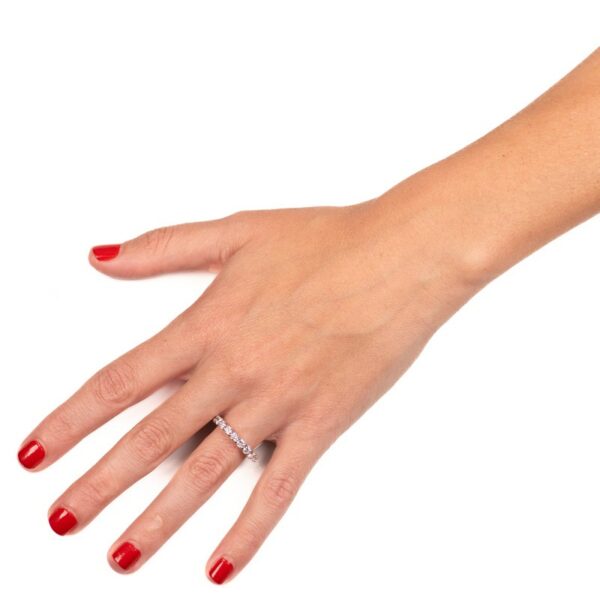 a woman's hand with red nail polish and a diamond ring