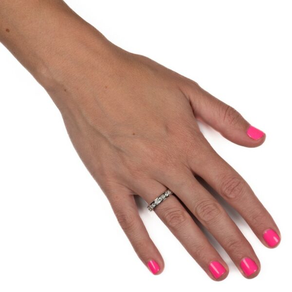 a woman's hand with pink nail polish and a diamond ring
