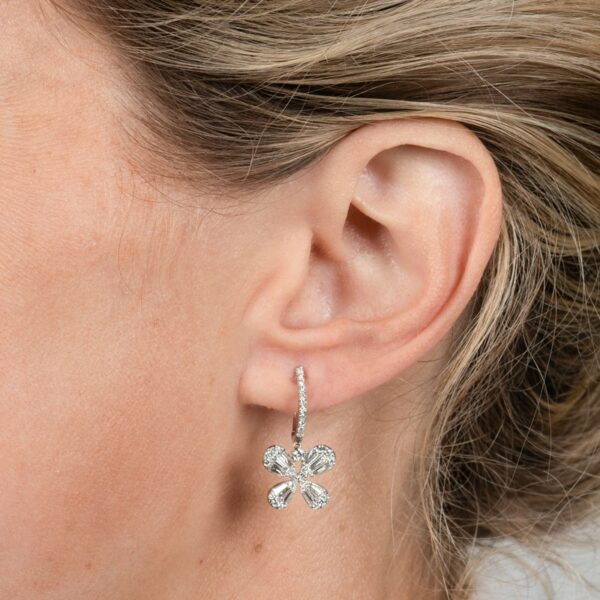 a close up of a woman's ear wearing a pair of earrings