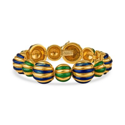 a gold bracelet with blue, green and yellow beads