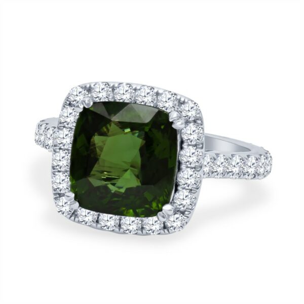 a ring with a green cushion cut stone surrounded by diamonds