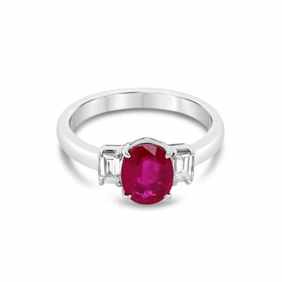 a white gold ring with an oval ruby and baguettes