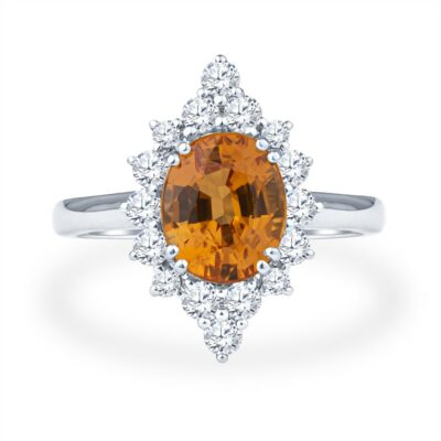 a ring with an orange stone surrounded by white diamonds
