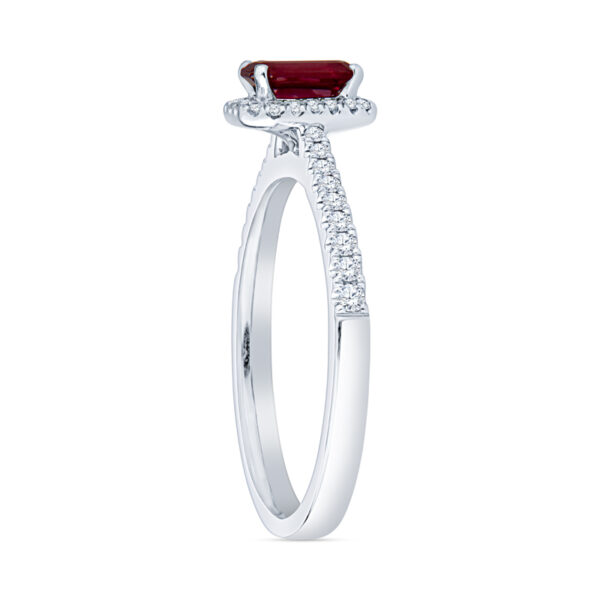 a white gold ring with a red stone and diamonds