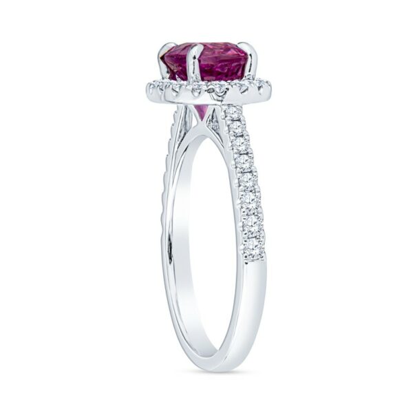 a white gold ring with an oval cut ruby stone and diamonds