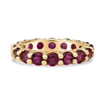 a gold ring with red stones