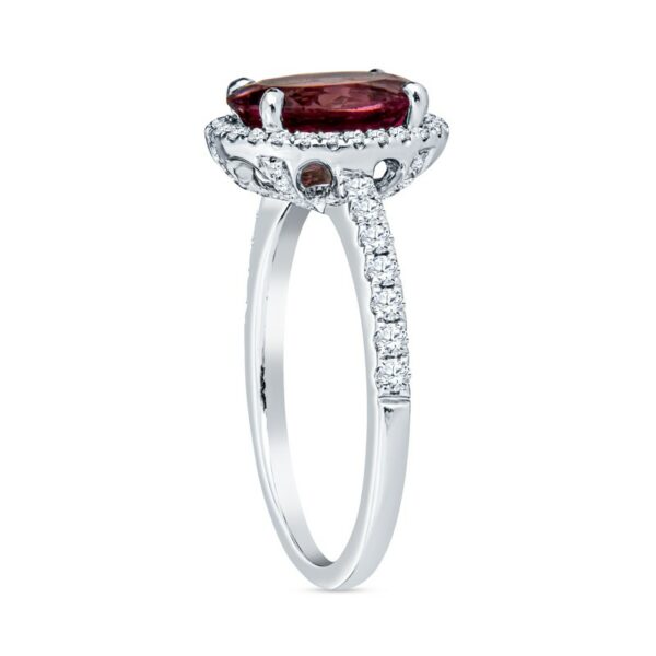 a ring with a red stone and diamonds