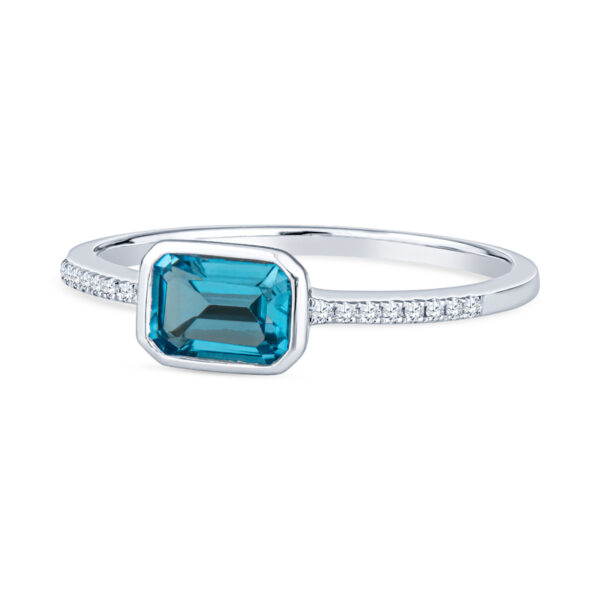 a blue topazte and diamond ring on a white background