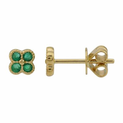 a pair of gold earrings with emerald stones