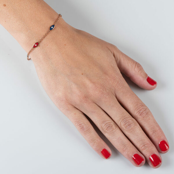 a woman's hand with red nail polish and a bracelet