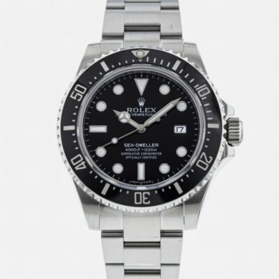 a rolex watch with black dials on a stainless steel bracelet