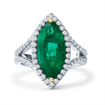 an emerald and diamond ring on a white background