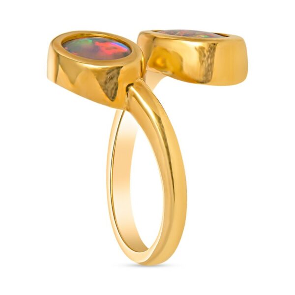 a gold ring with a red stone in the middle