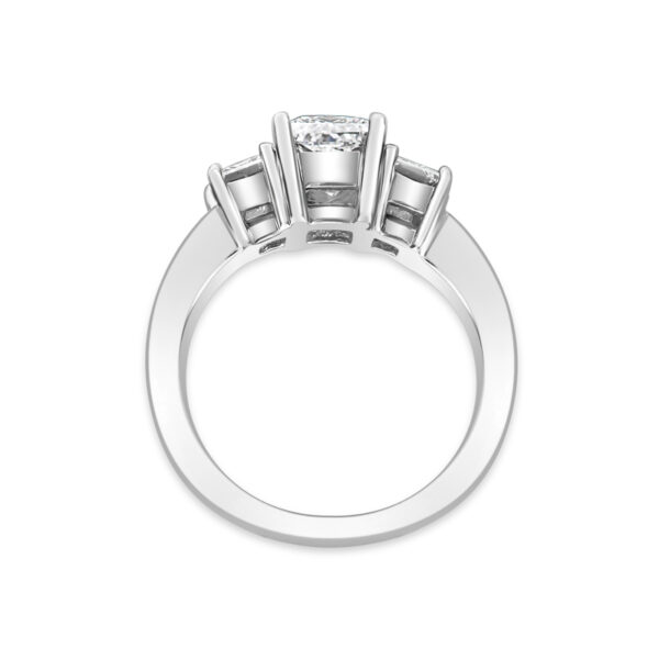 a three stone engagement ring on a white background