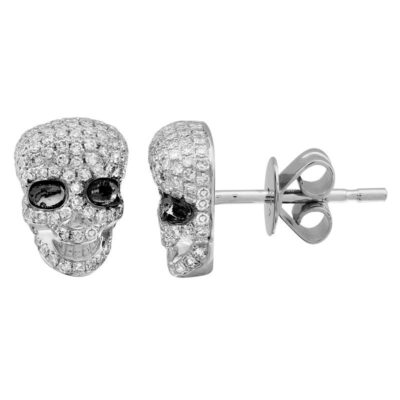 a pair of skull earrings with black and white stones