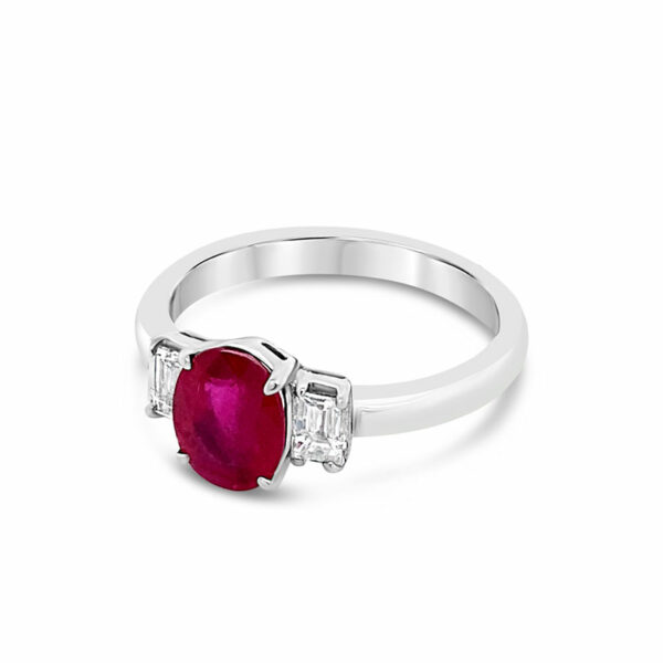 a white gold ring with an oval ruby and baguettes