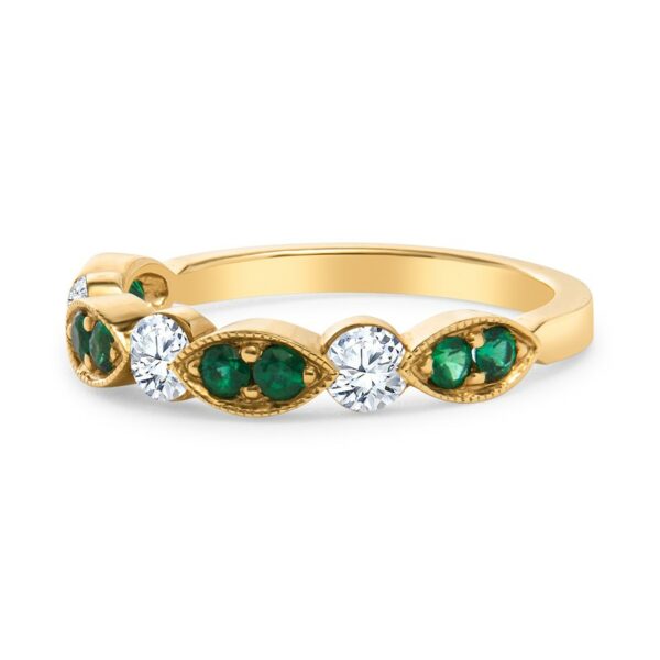 a yellow gold ring with emerald and diamonds