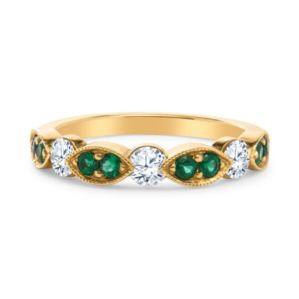 a yellow gold ring with green and white stones