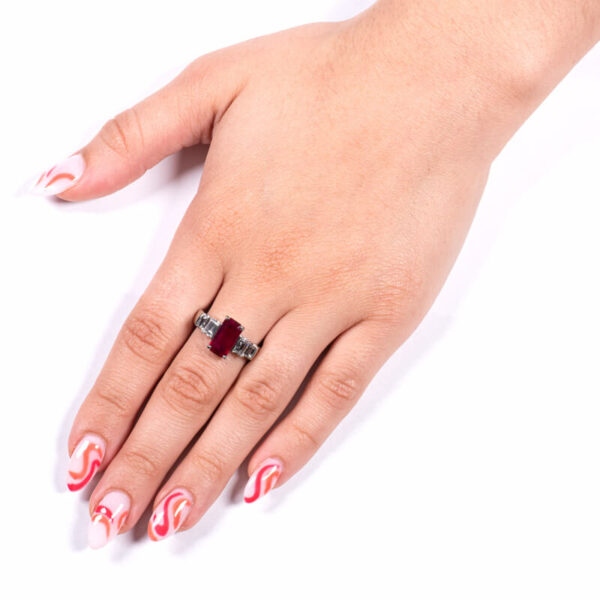a woman's hand with red and white nail polish