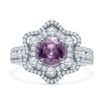 a pink sapphire and diamond ring on a white background