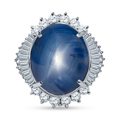a ring with a blue stone surrounded by diamonds