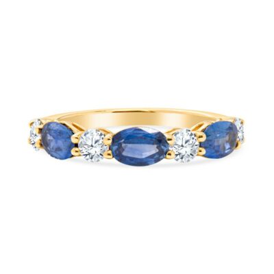 a yellow gold ring with three blue stones