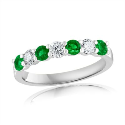 a white gold ring with emerald and diamond stones